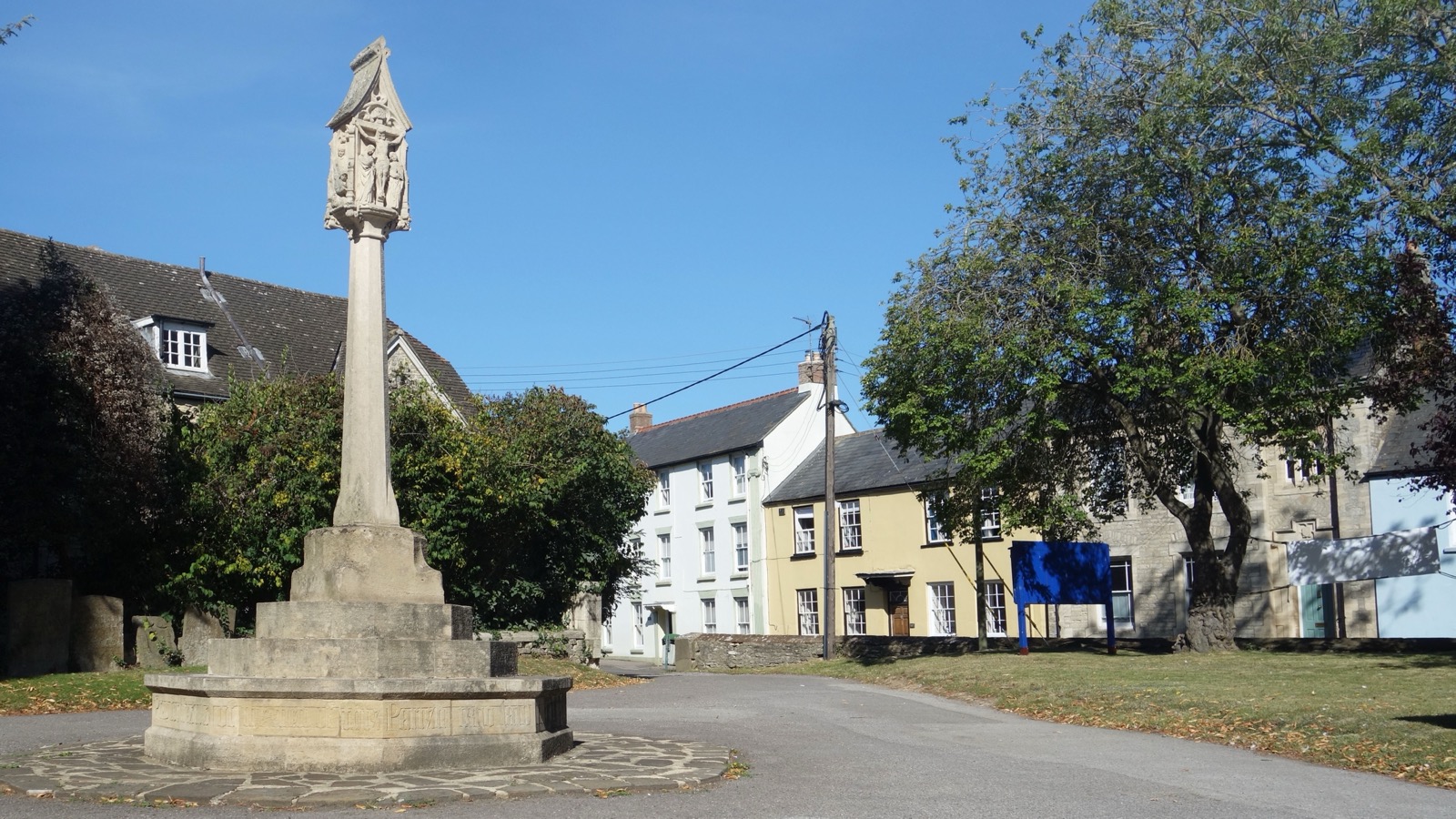 Stone Celtic cross of the Bicester War Memorial inscribed in tribute to service personnel, photographed in September 2019.