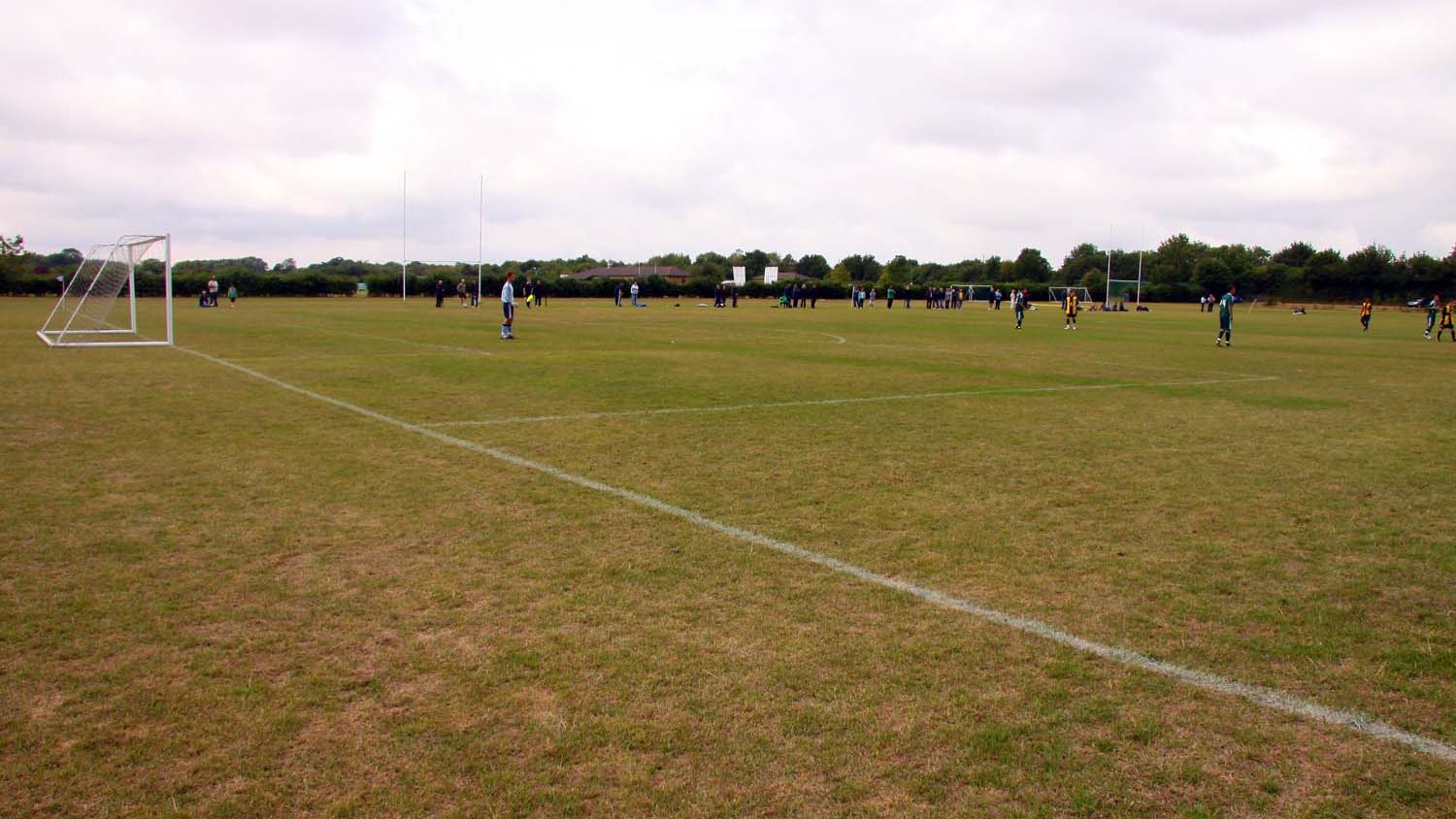Grass football pitch with goalposts and perimeter netting at the Bicester Sports Association Ground in Chesterton, photographed in August 2010.