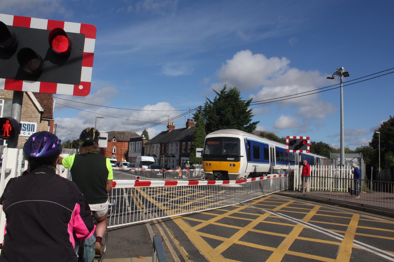 A Chiltern Railways passenger train crossing the London Road level crossing with barriers down in Bicester.