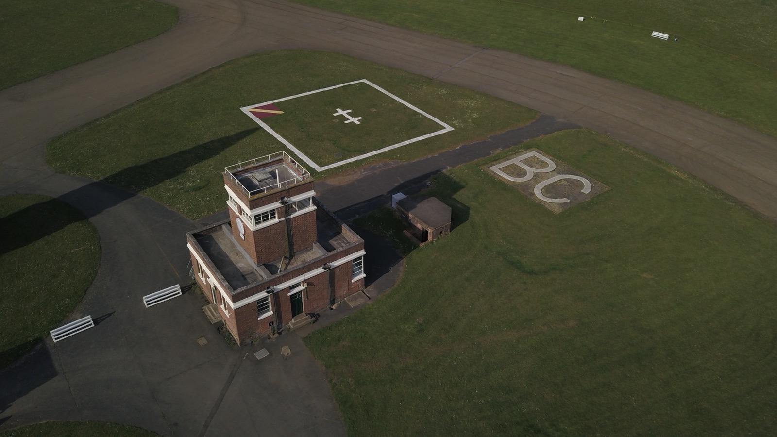 Aerial view of the restored 1930s RAF Bicester Watch Office and grass airfield ground markings at Bicester Heritage, photographed in April 2020.