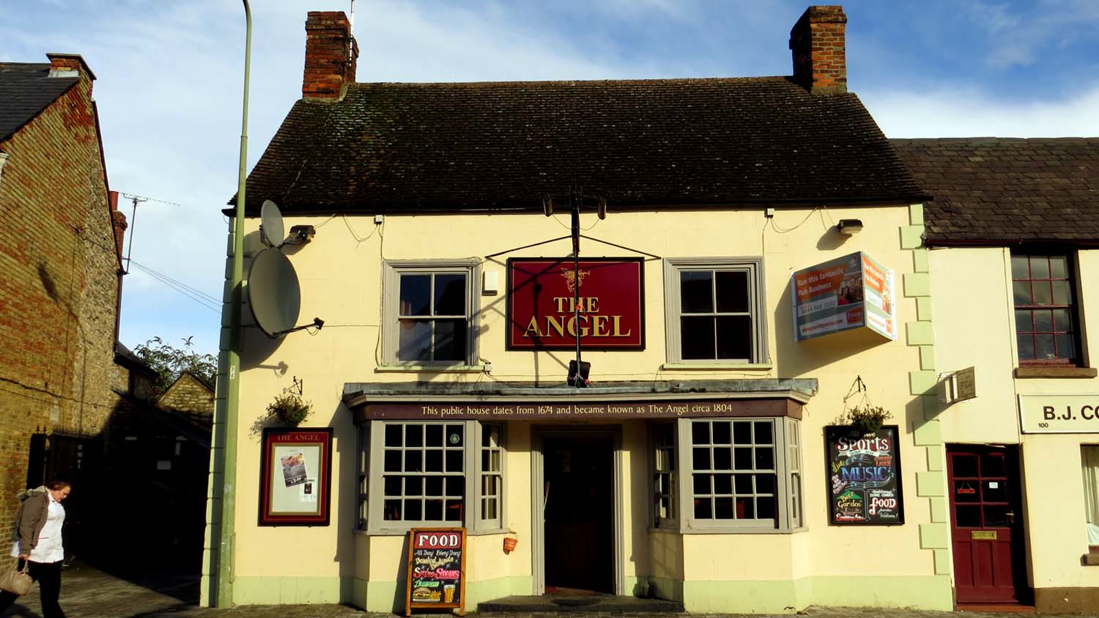 Front elevation of The Angel pub on Sheep Street in Bicester with traditional hanging sign.